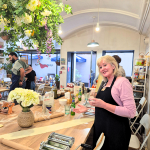 Women enjoying an Italian cooking class with wine and charcuterie – learning to make pasta and classic dishes together with Culture Calendar
