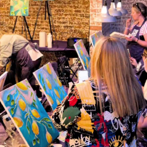 Women enjoying a Cocktail and Canvas night with Culture Calendar – painting on canvas under the guidance of a tutor while sipping cocktails and making new friends
