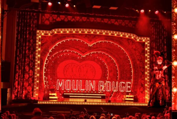 Audience enjoying Moulin Rouge! The Musical live theatre performance.