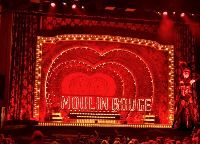 Audience enjoying Moulin Rouge! The Musical live theatre performance.